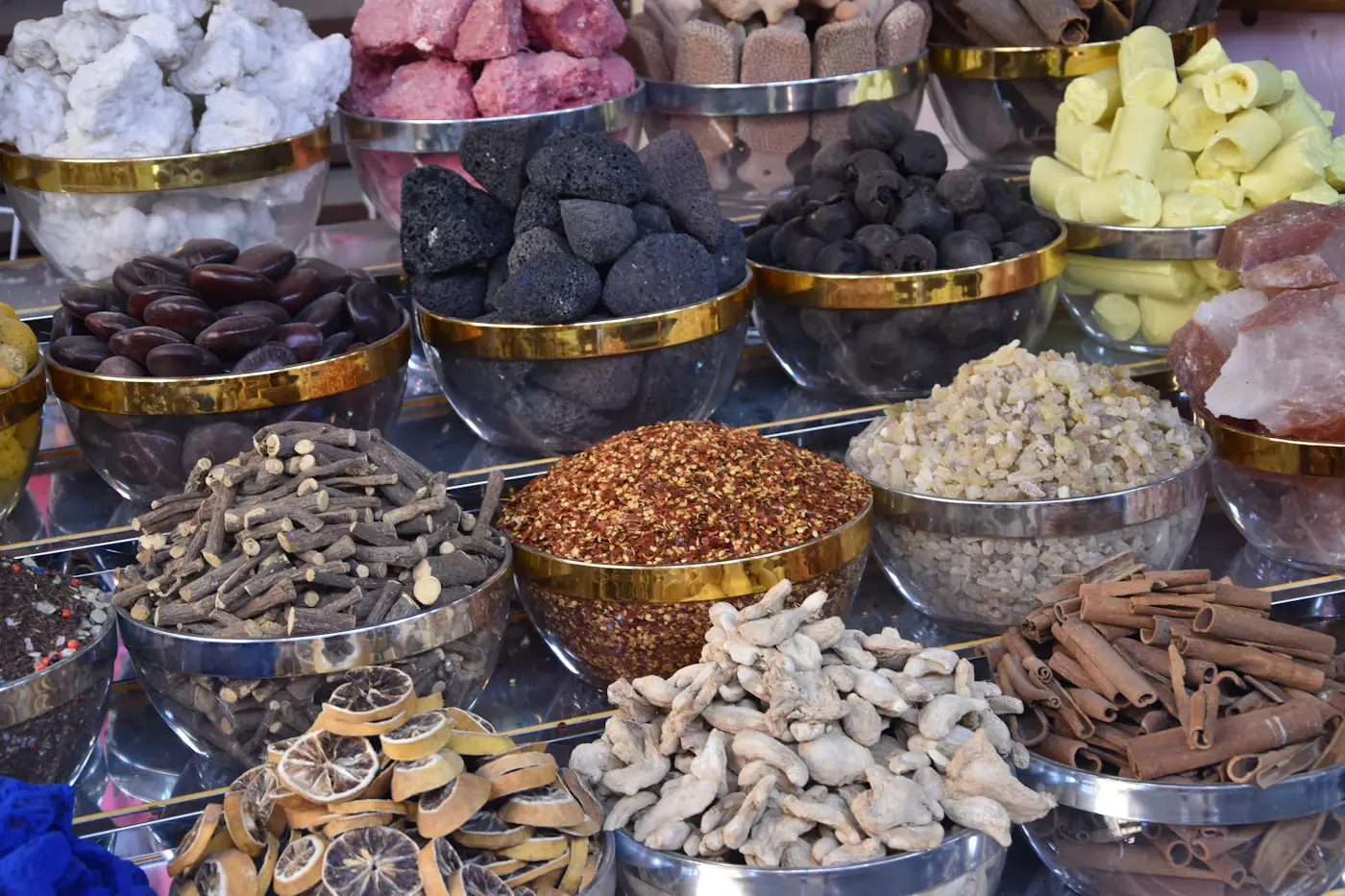 Metal bowls filled with dried roots, fungi and Chinese herbs at a market